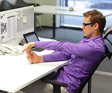 Male exercising at work on his desk