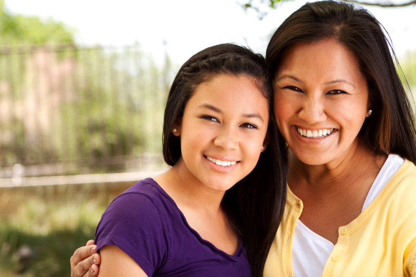 mother and teenage daughter smiling