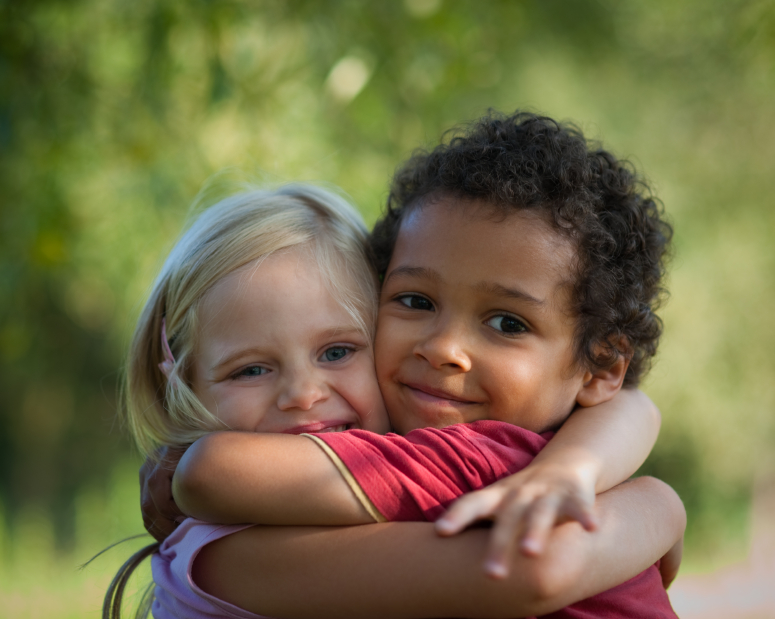two kids are hugging each other