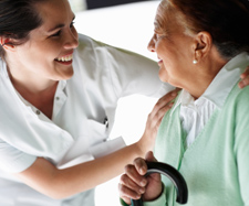 nurse helping elderly woman