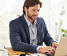 male typing on laptop