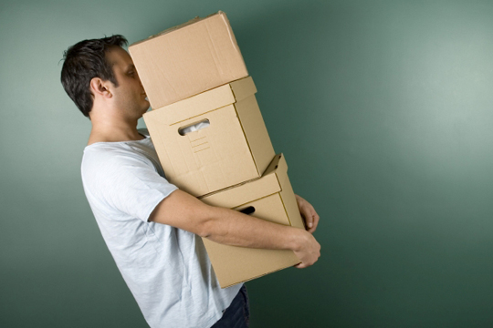 Young man carrying boxes