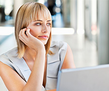 female looking outside while using the laptop