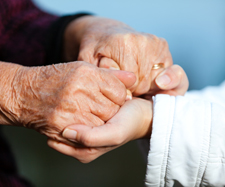 old parent holding onto their child's hand