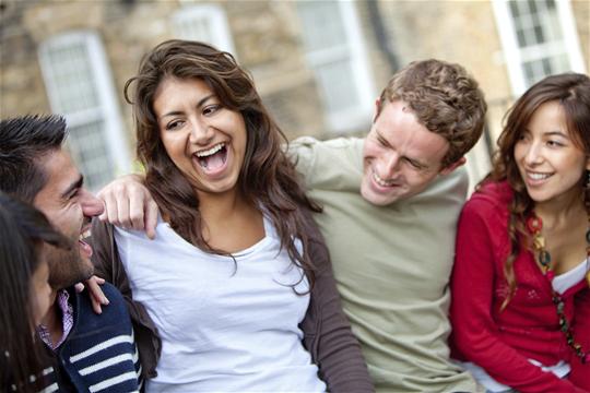 Friends standing together and laughing