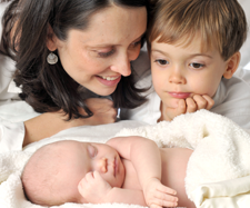 mom introducing son to his new baby brother
