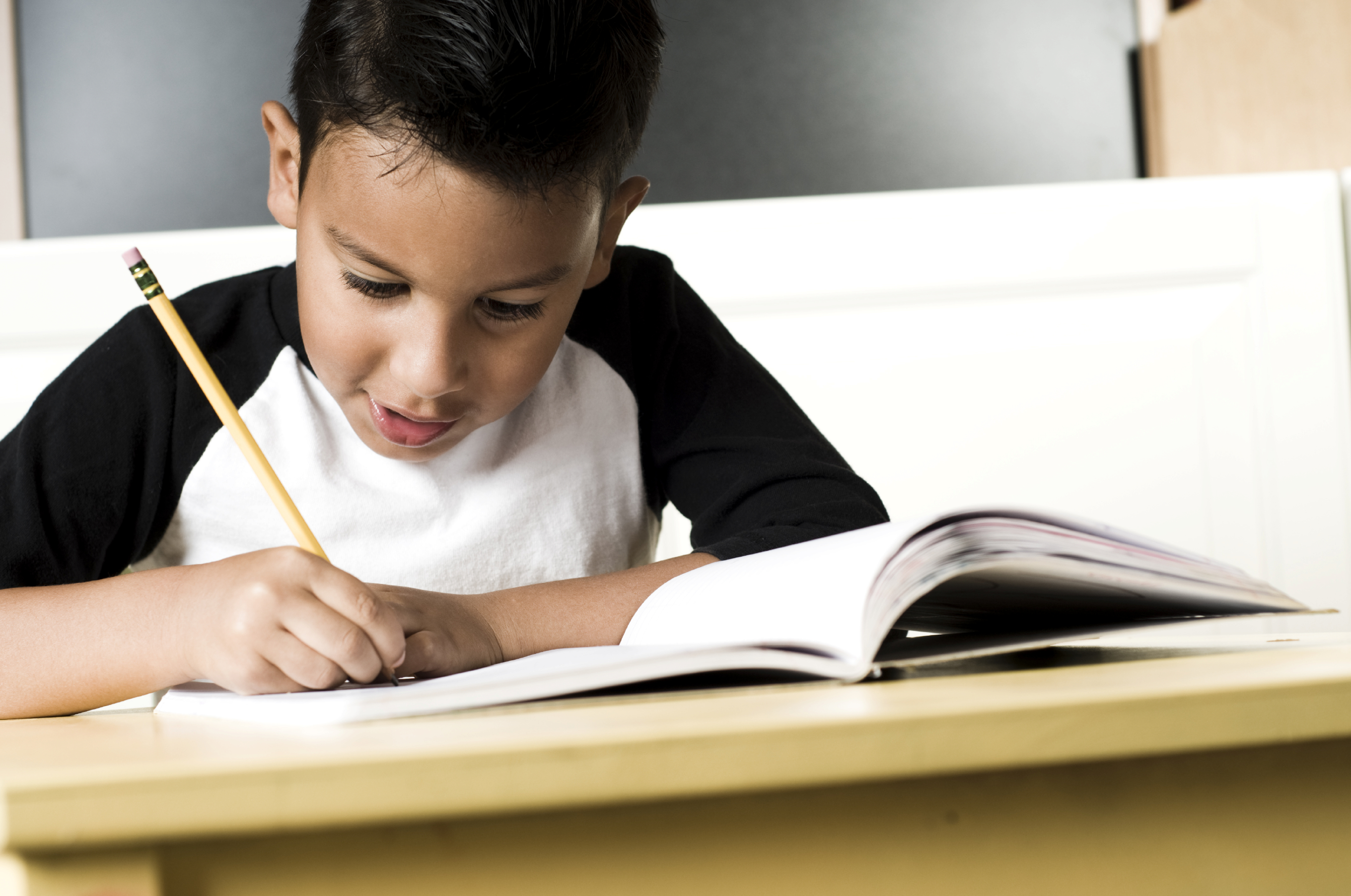 young boy doing homework at the table